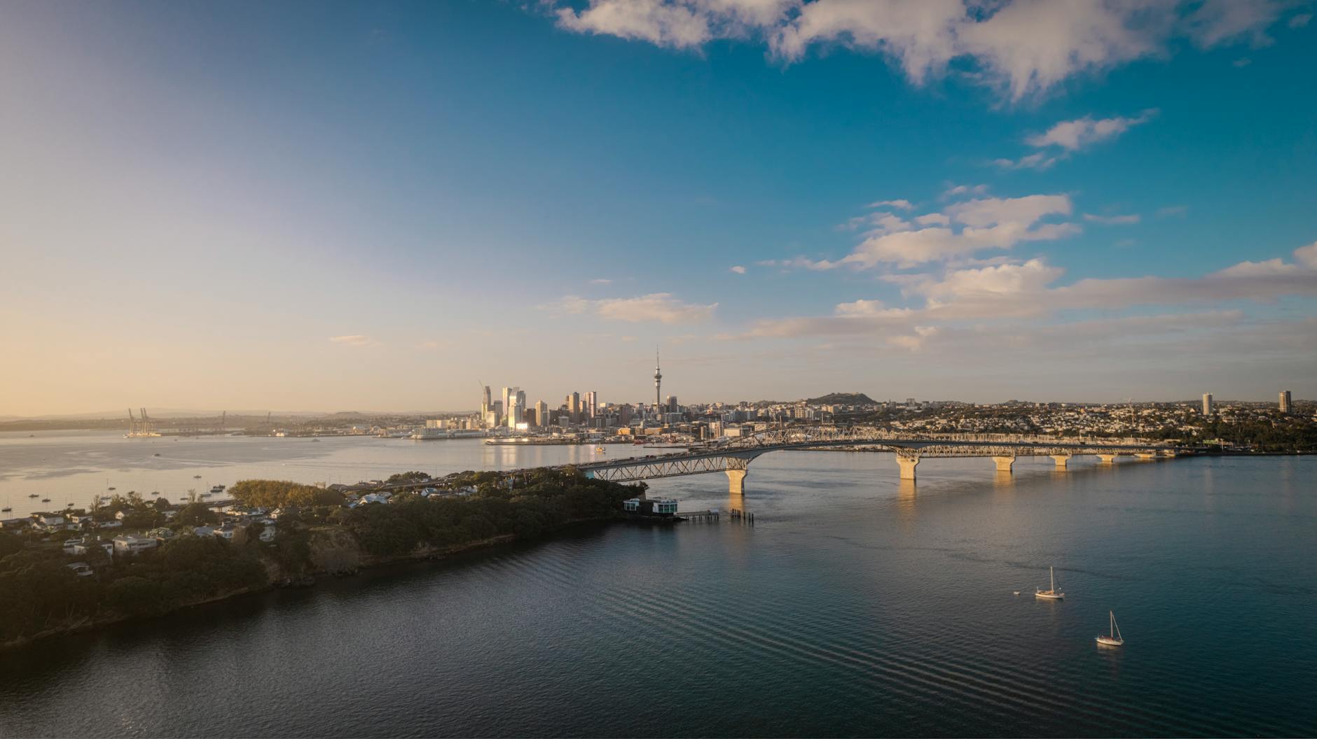 Aerial view of Auckland city skyline and Harbour Bridge at sunset