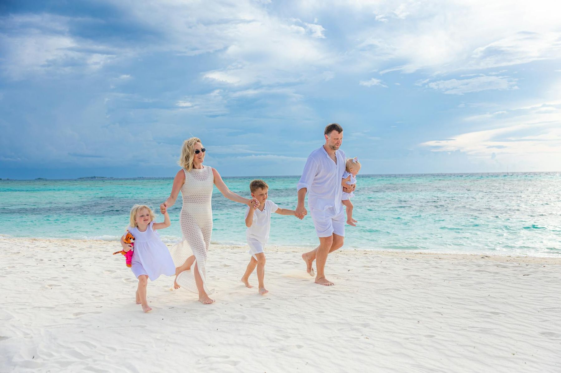 Family with children enjoying a beach day in Auckland