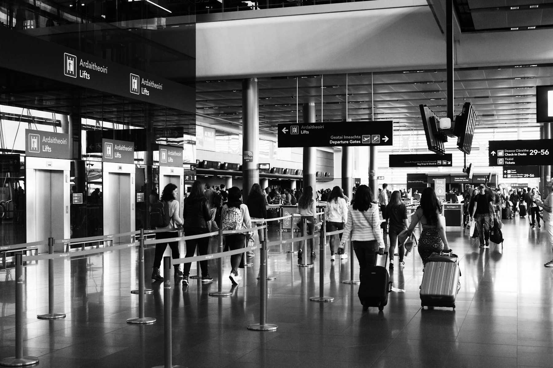 Airport terminal with travelers and luggage similar to Auckland Airport