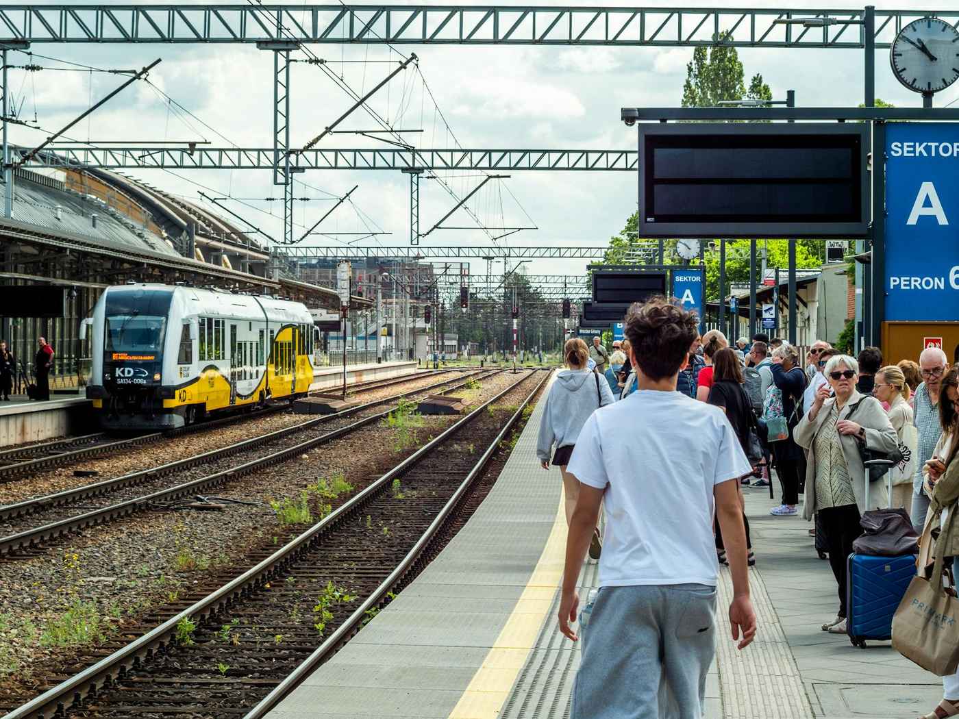 Commuter train at a station platform similar to Auckland's Puhinui Station