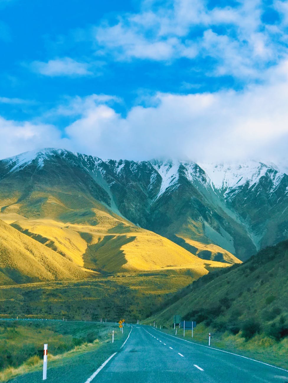 New Zealand countryside road with rolling green hills