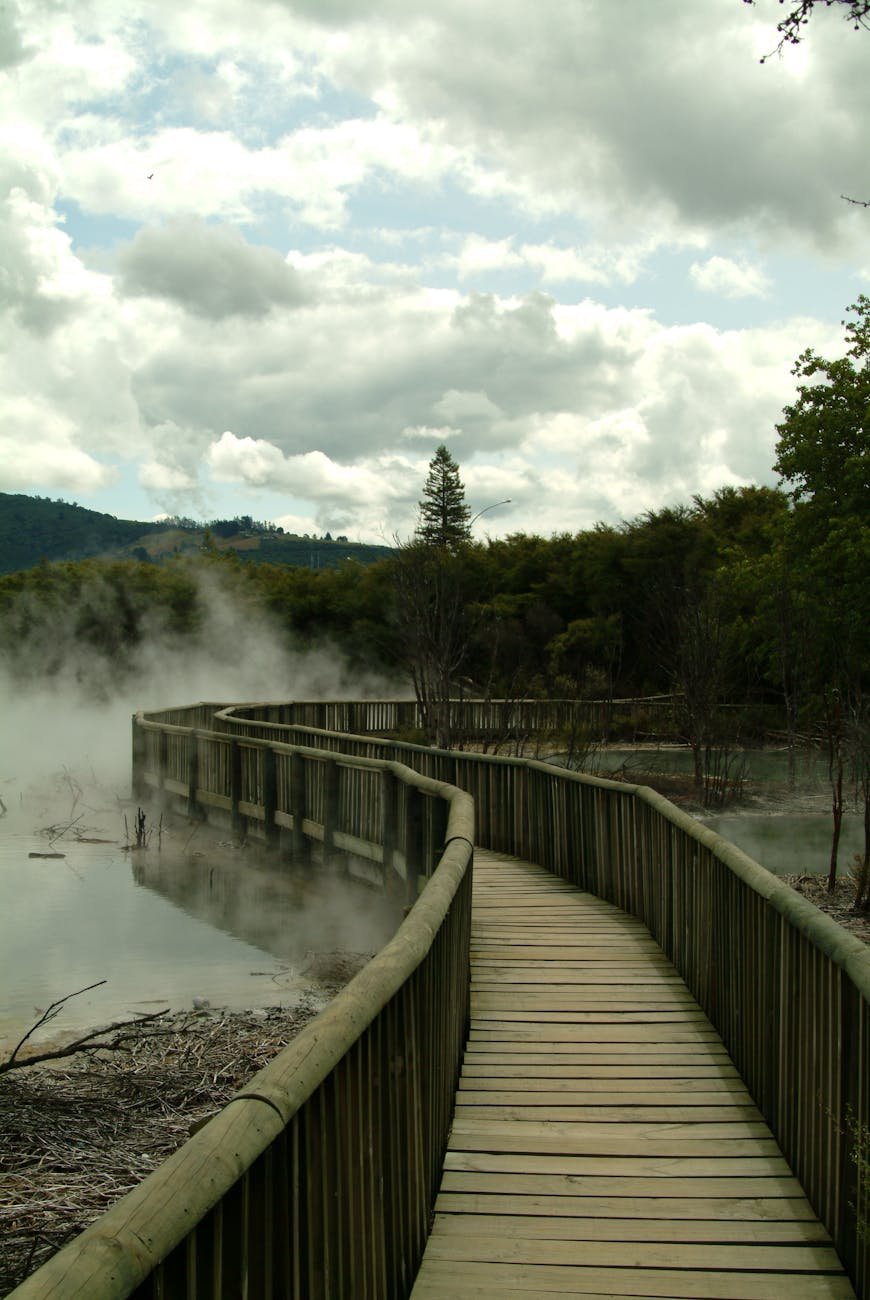 Lake Rotorua mirror-still water at sunrise with steam rising