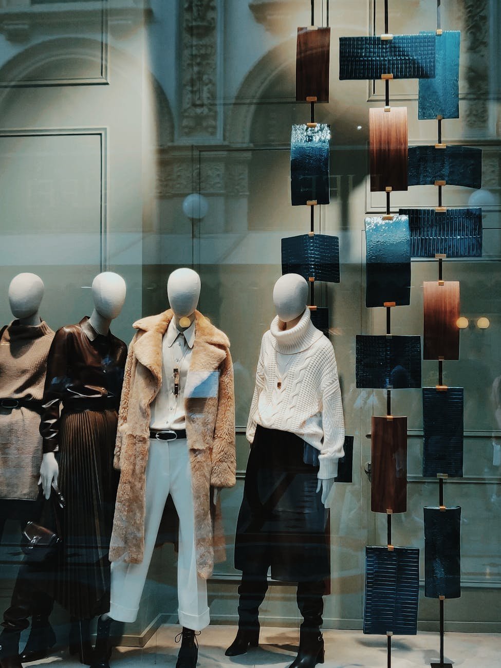 Fashion store window display with mannequins and signage