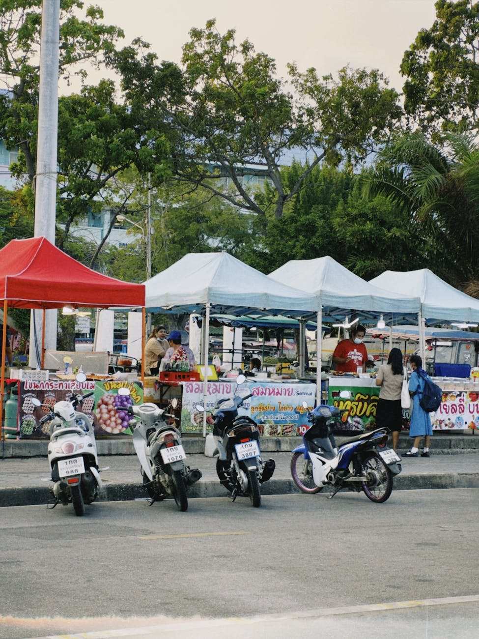 Outdoor weekend market with food and craft stalls