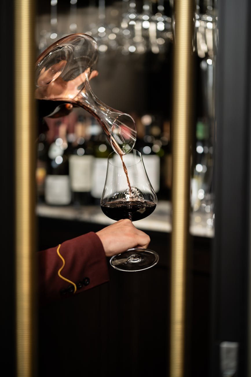 Sommelier pouring wine at fine dining restaurant