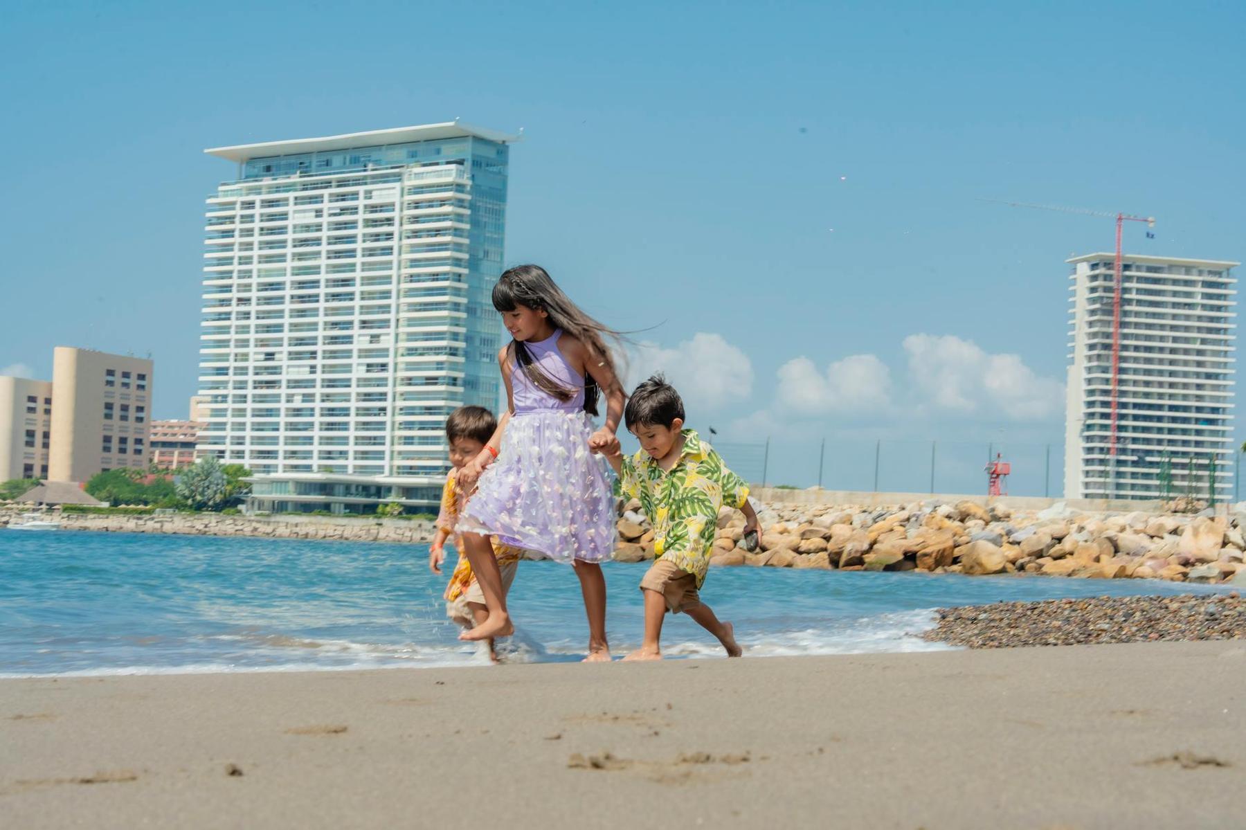Children playing on a safe Auckland harbour beach