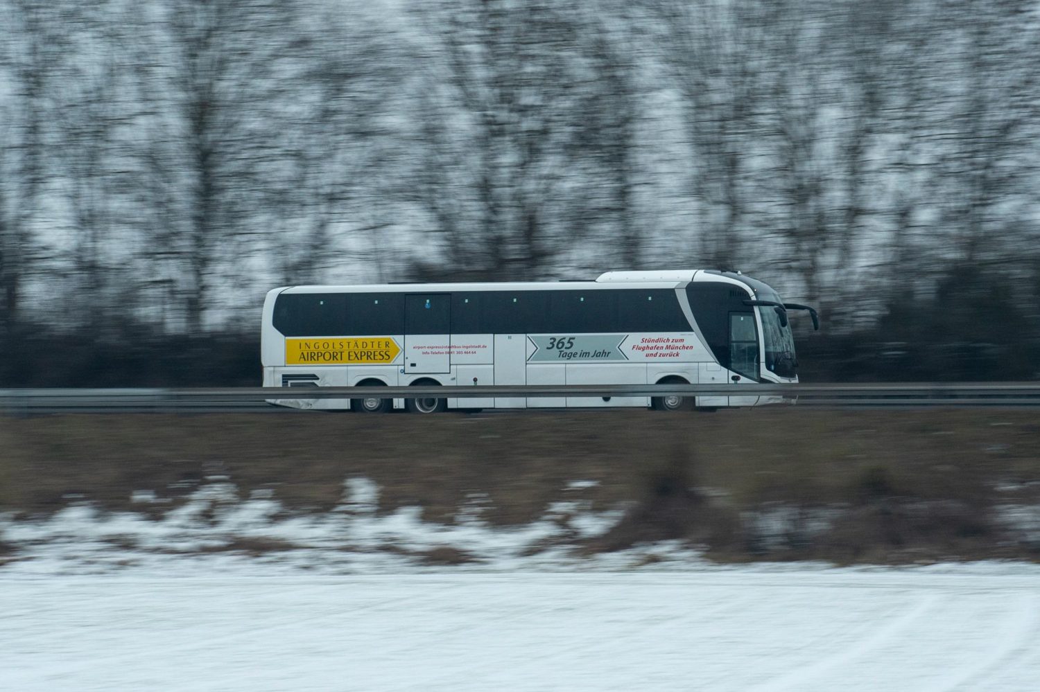 Express airport shuttle bus loading passengers outside a terminal