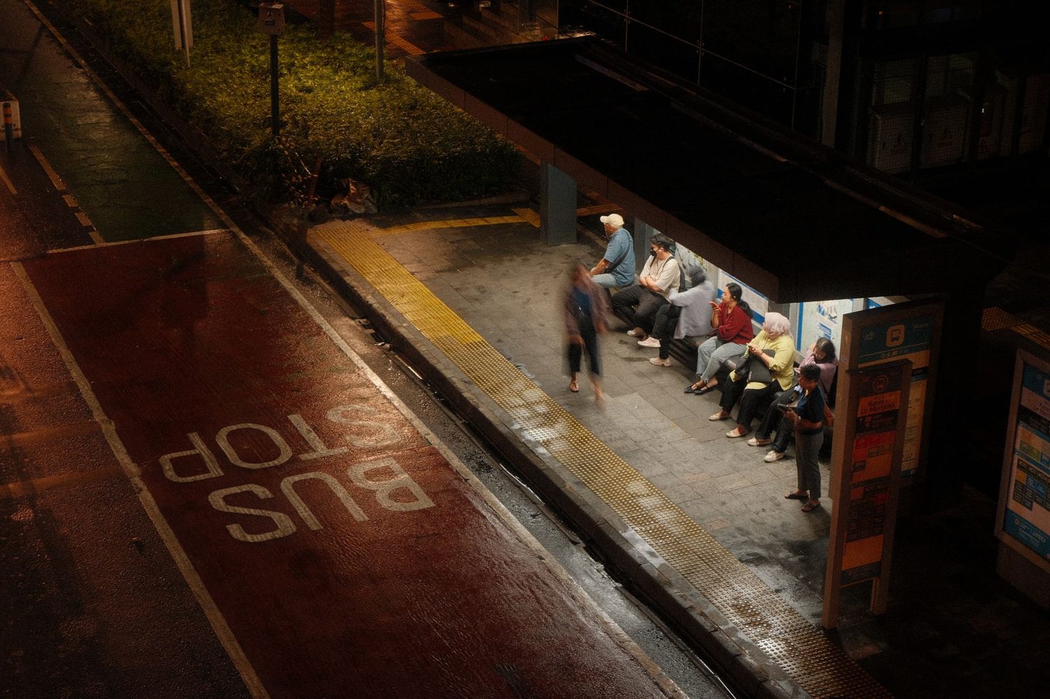Passengers waiting at an Auckland bus stop