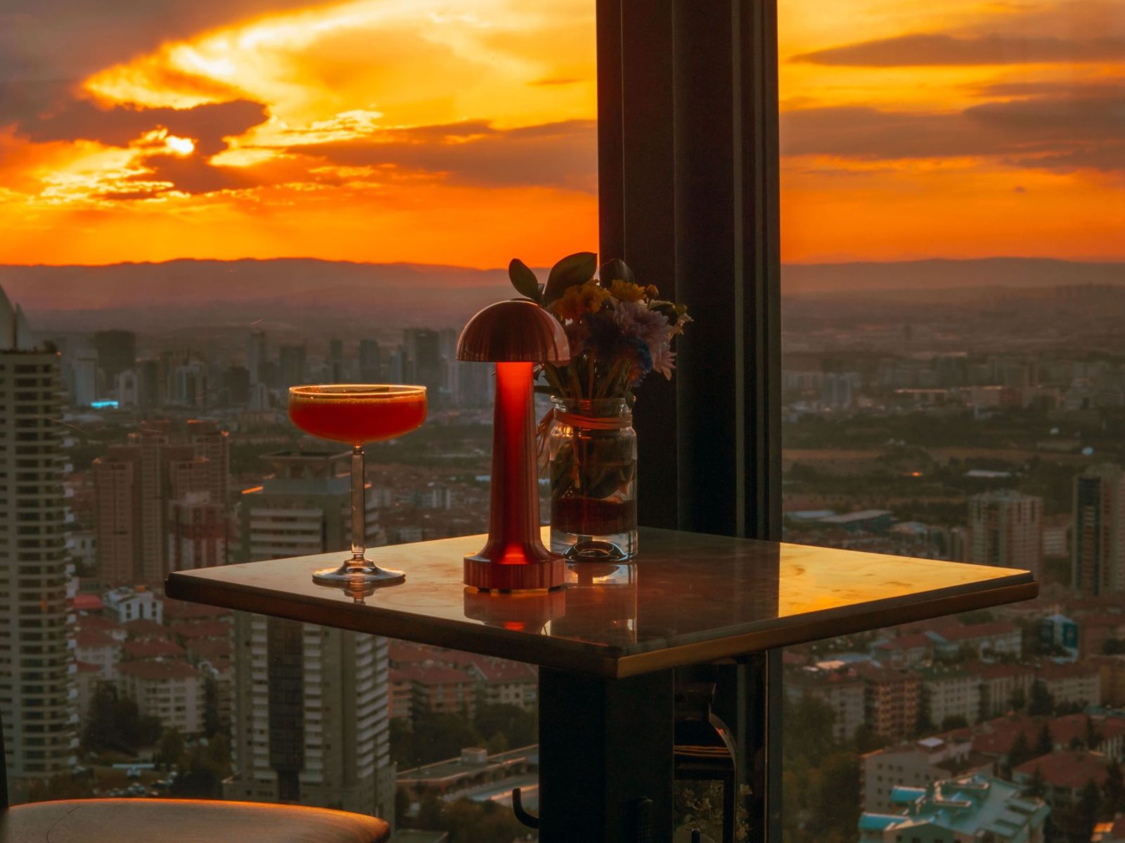 Evening cocktails at an Auckland rooftop bar overlooking the city