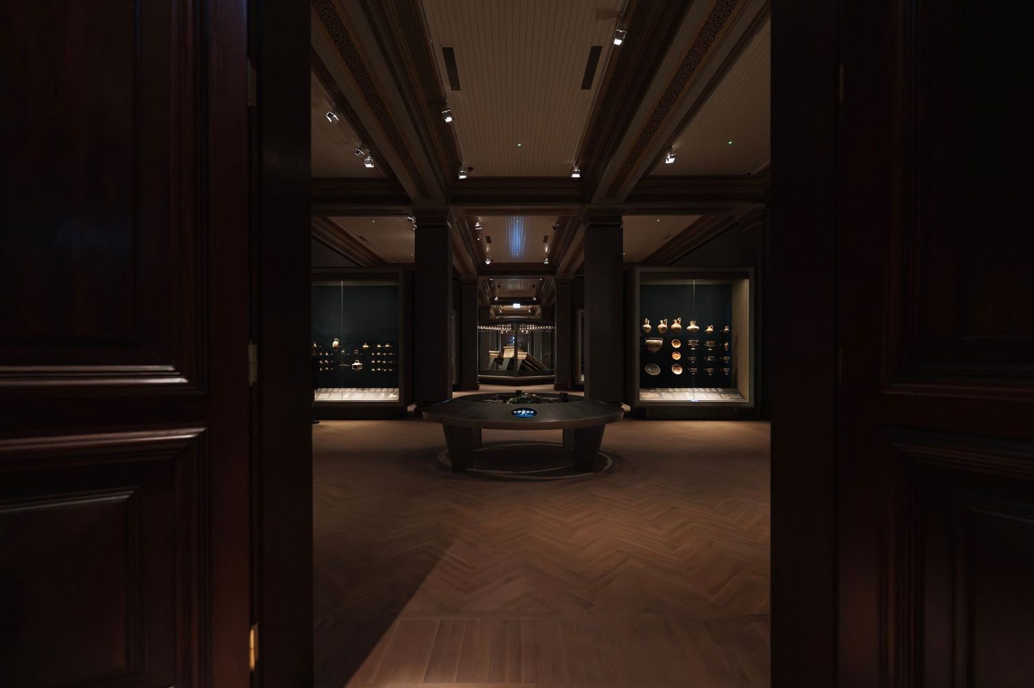 A grand museum exhibition hall with carved cultural displays