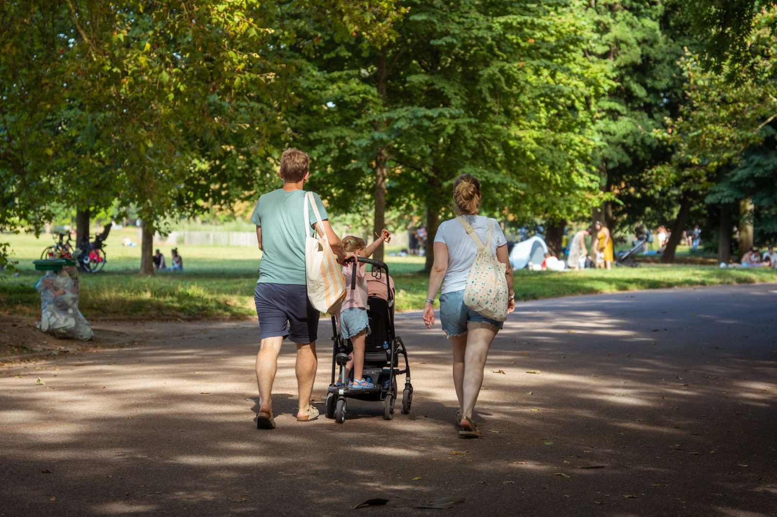Parents pushing a stroller along a flat Auckland waterfront path