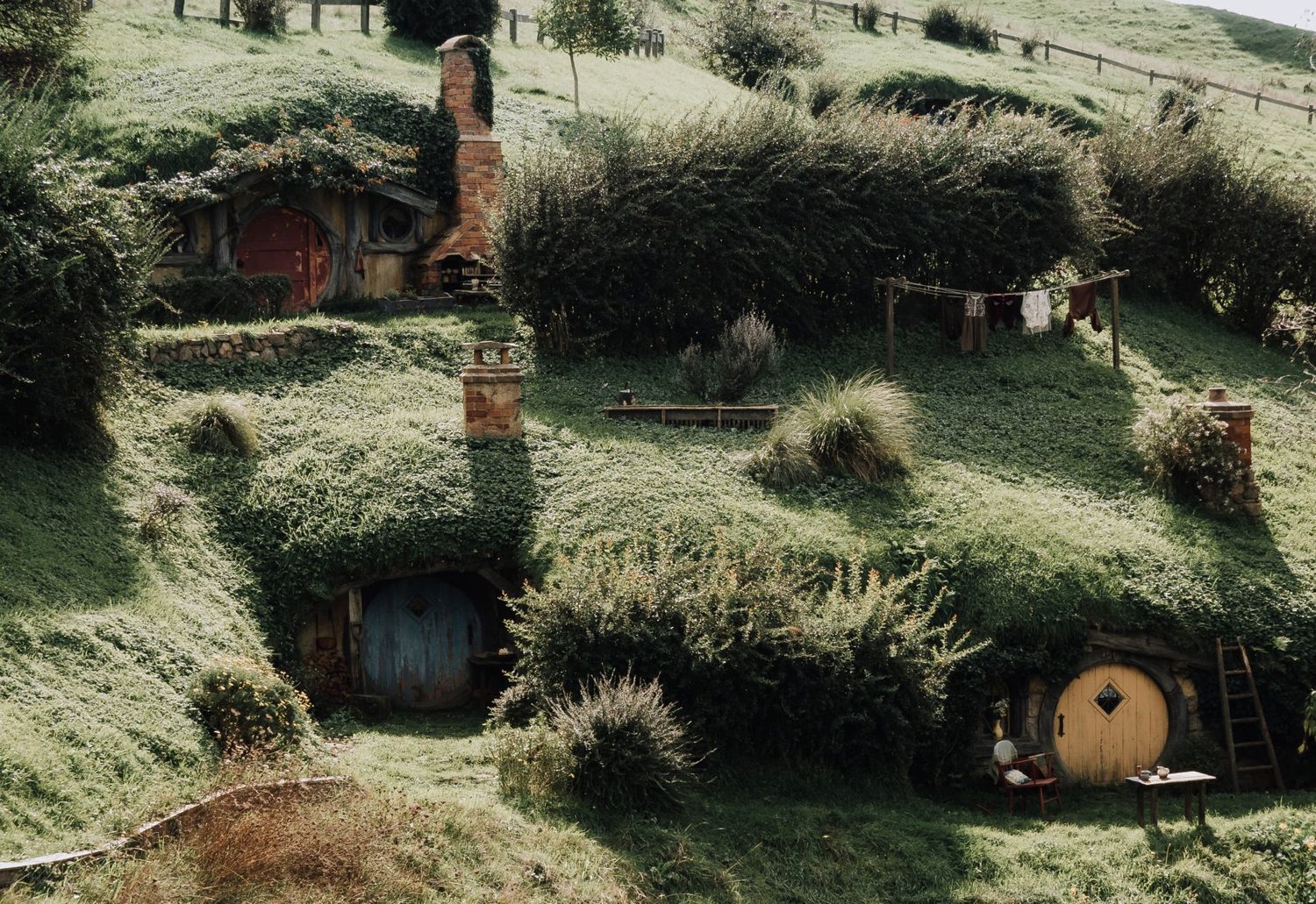 Hobbit hole with a round green door on the Hobbiton day trip from Auckland