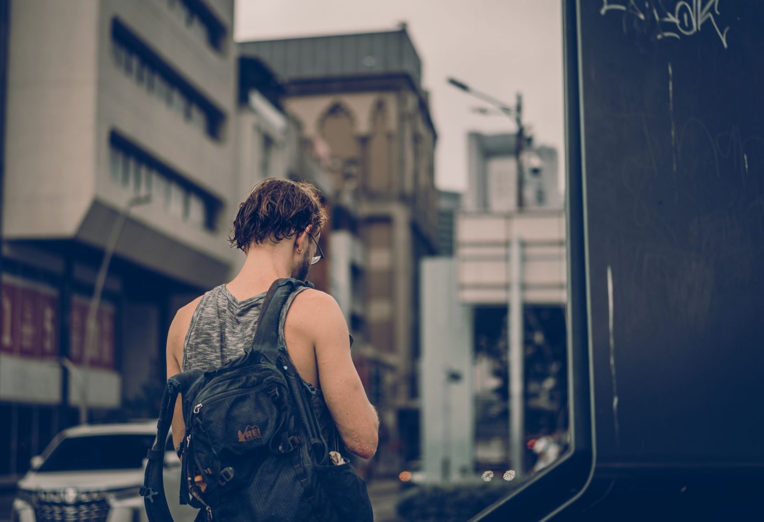 Traveller walking safely through Auckland with a backpack