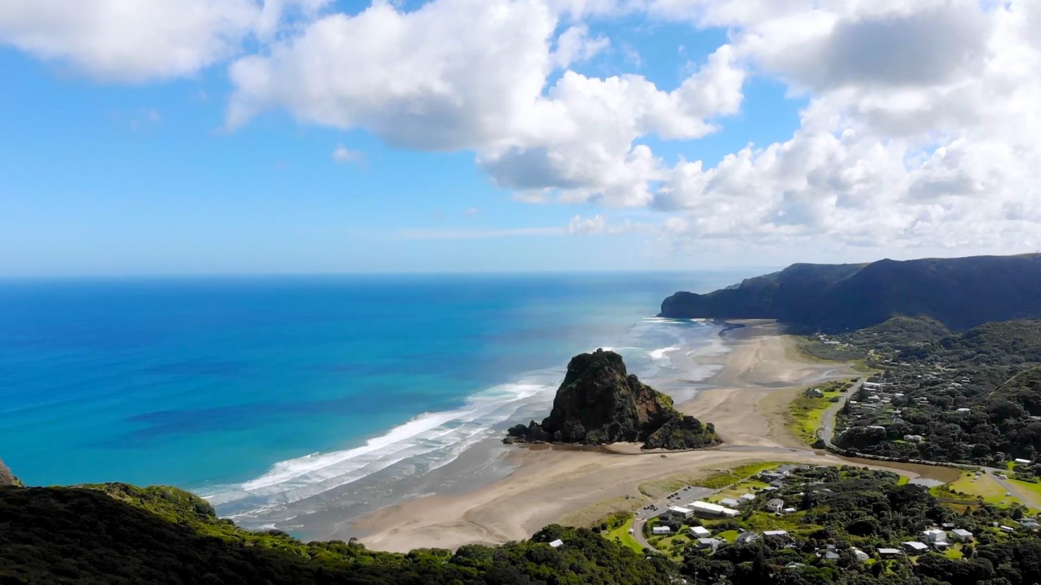 Piha Beach, Auckland's black-sand surf beach with Lion Rock at its centre