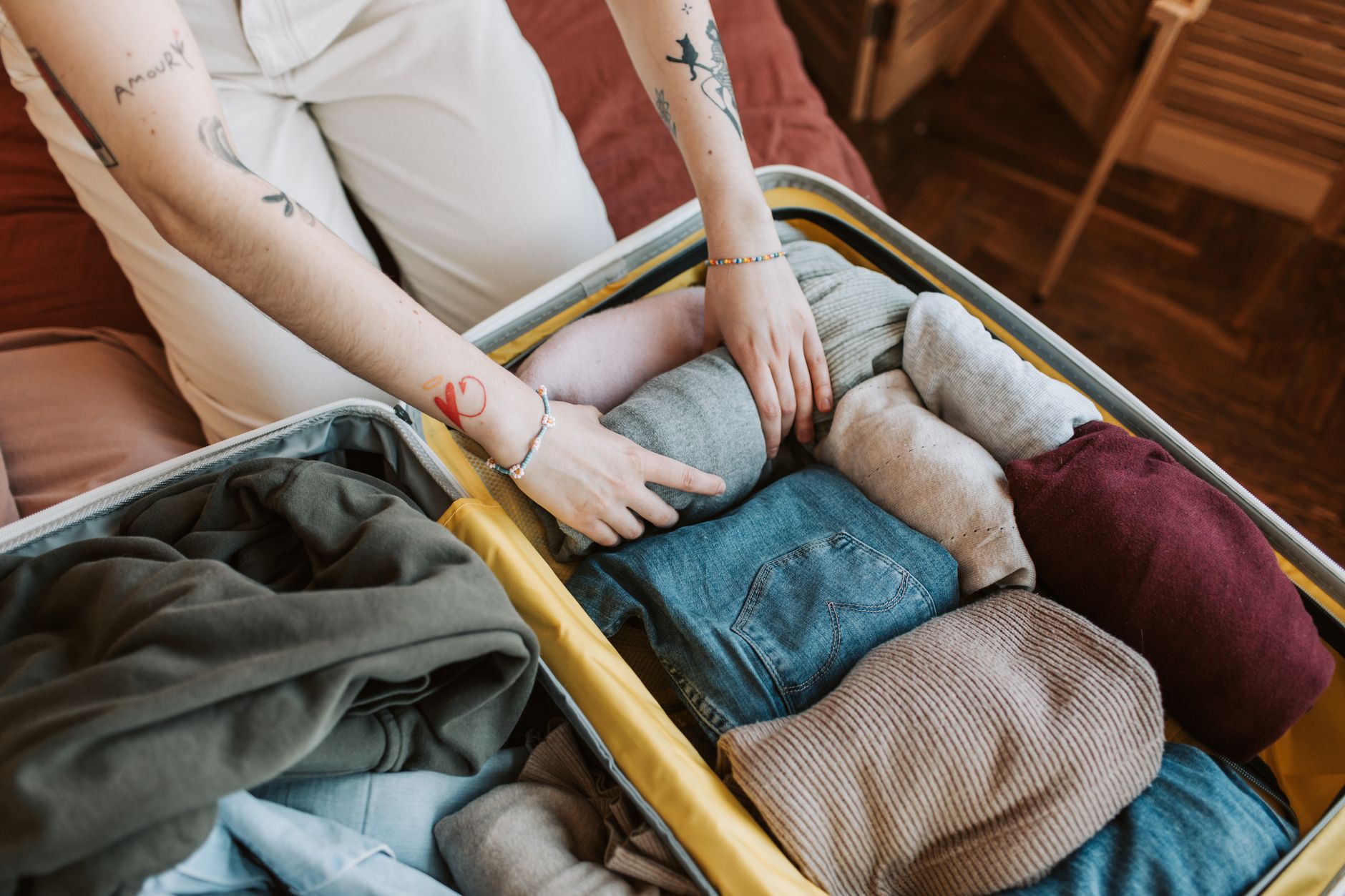 Clothes folded into a suitcase for a trip to Auckland