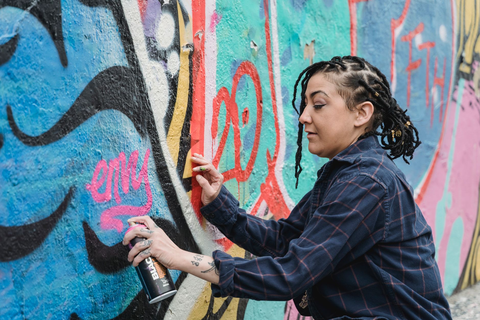 A street artist painting a mural in Auckland