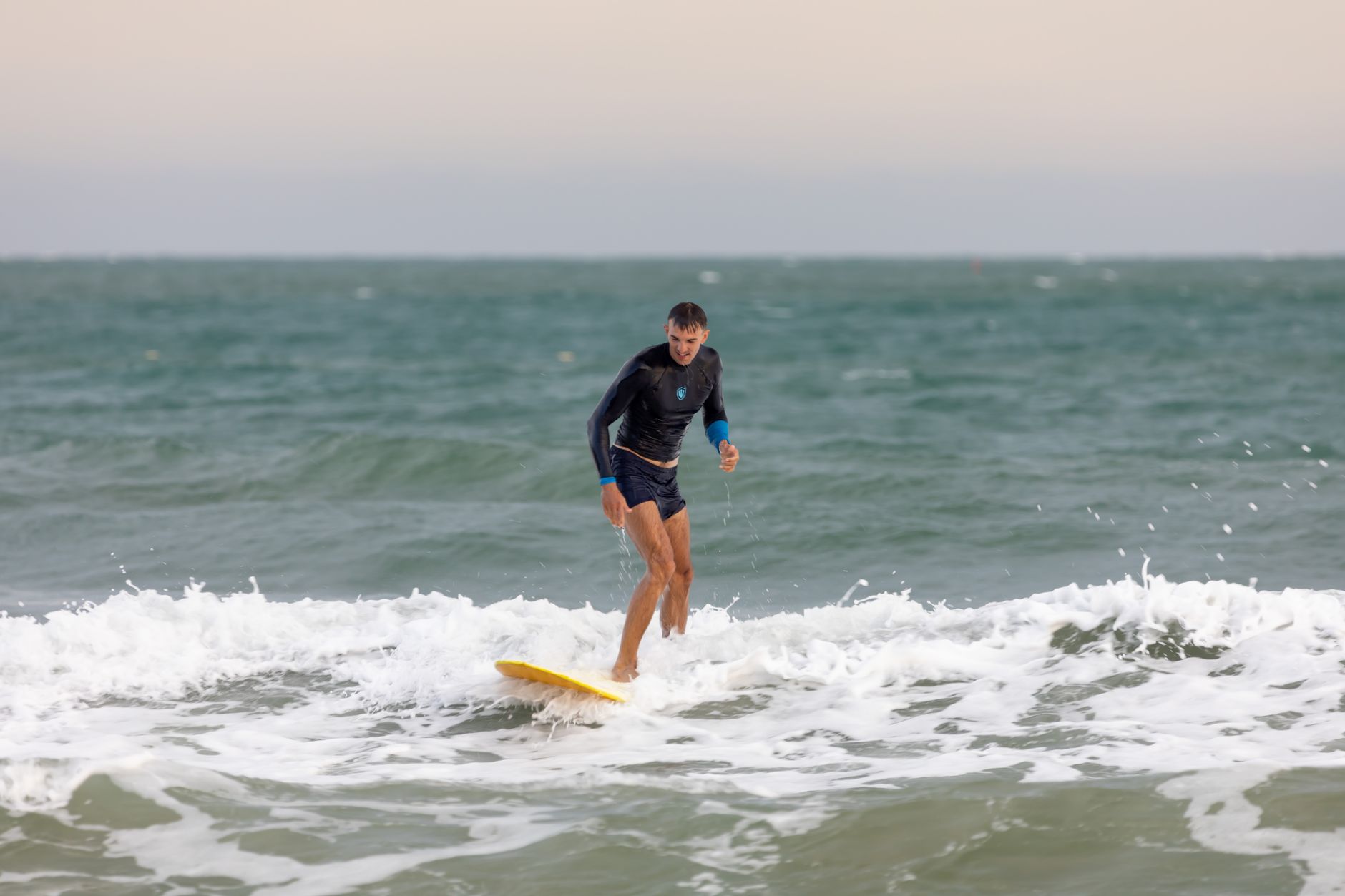A surf lesson on an Auckland west coast beach with teenagers
