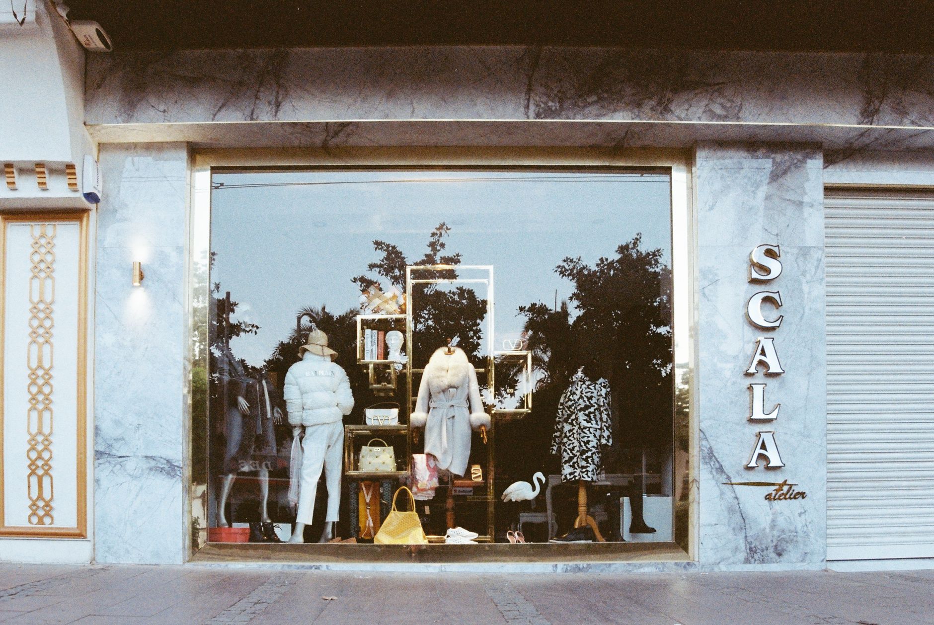 A boutique clothing storefront with a window display.