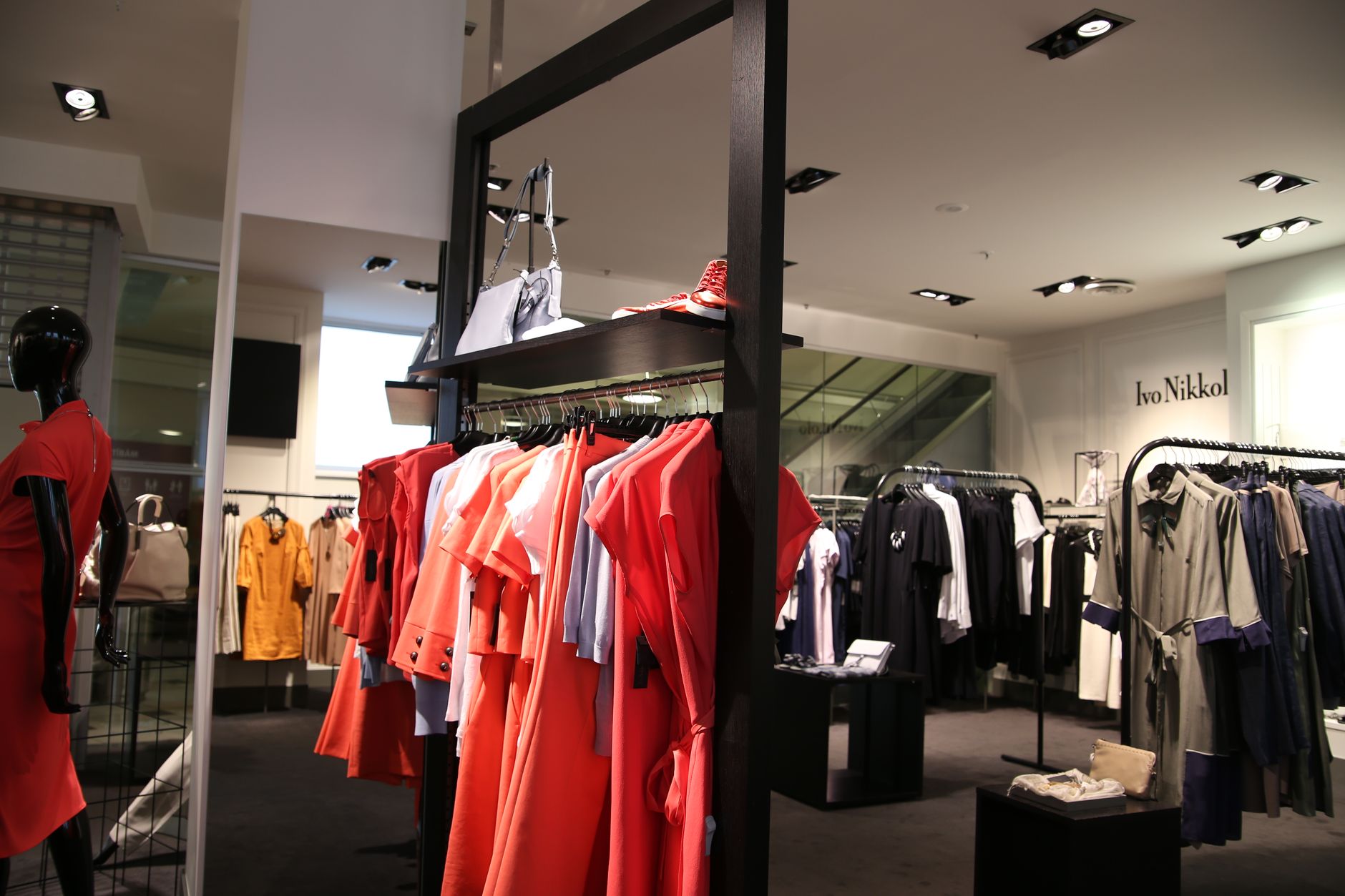 Designer clothing on racks inside a fashion boutique.