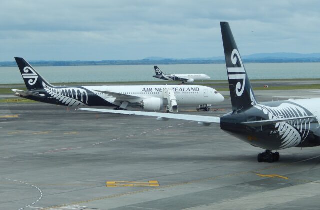 Air New Zealand Boeing 787 and Airbus A320 aircraft on the apron at Auckland Airport with the harbour behind
