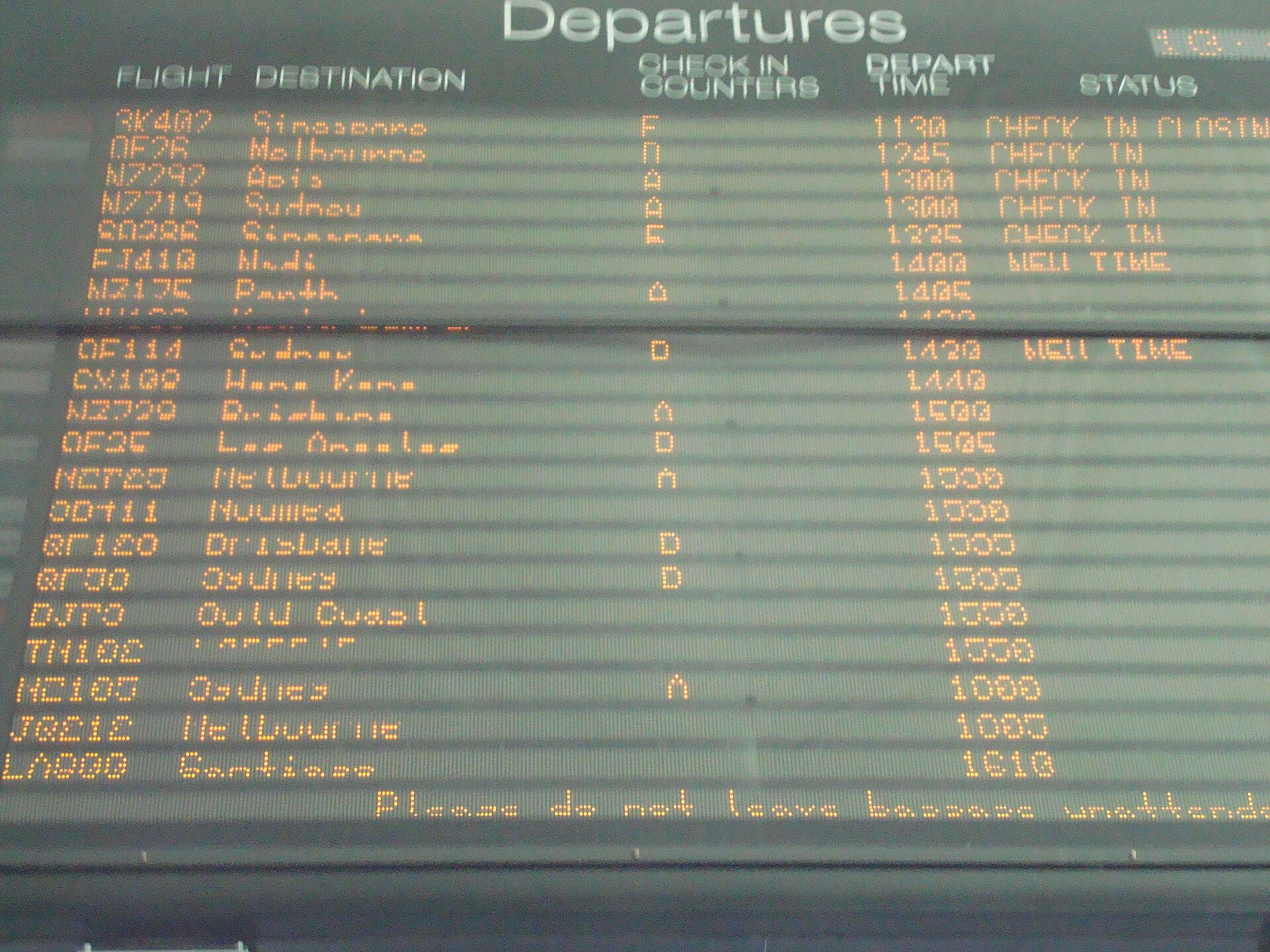 An international departures board at Auckland Airport listing flights, check-in counters and departure times