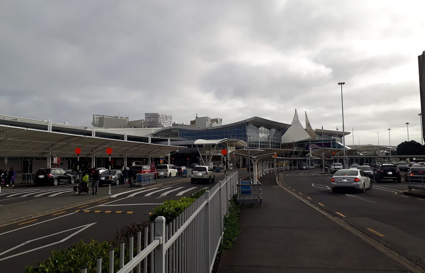The kerbside frontage of Auckland Airport's international terminal, with covered walkways and traffic