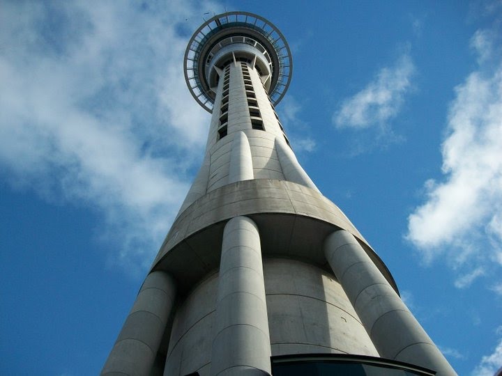 The Auckland Sky Tower seen looking straight up from its base against a blue sky
