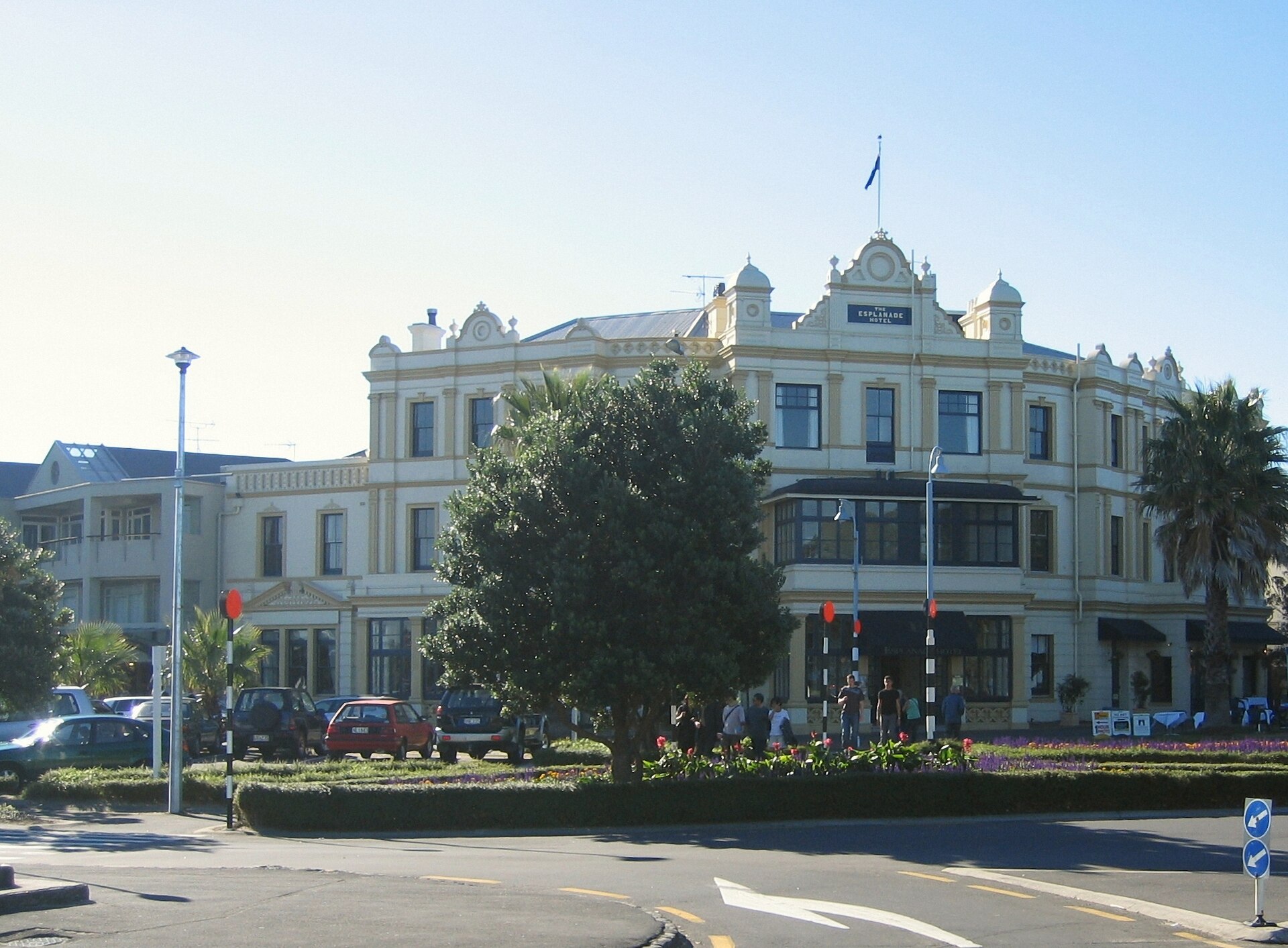 The Edwardian Esplanade Hotel on the corner opposite the Devonport ferry wharf, with palms and a flowerbed in front