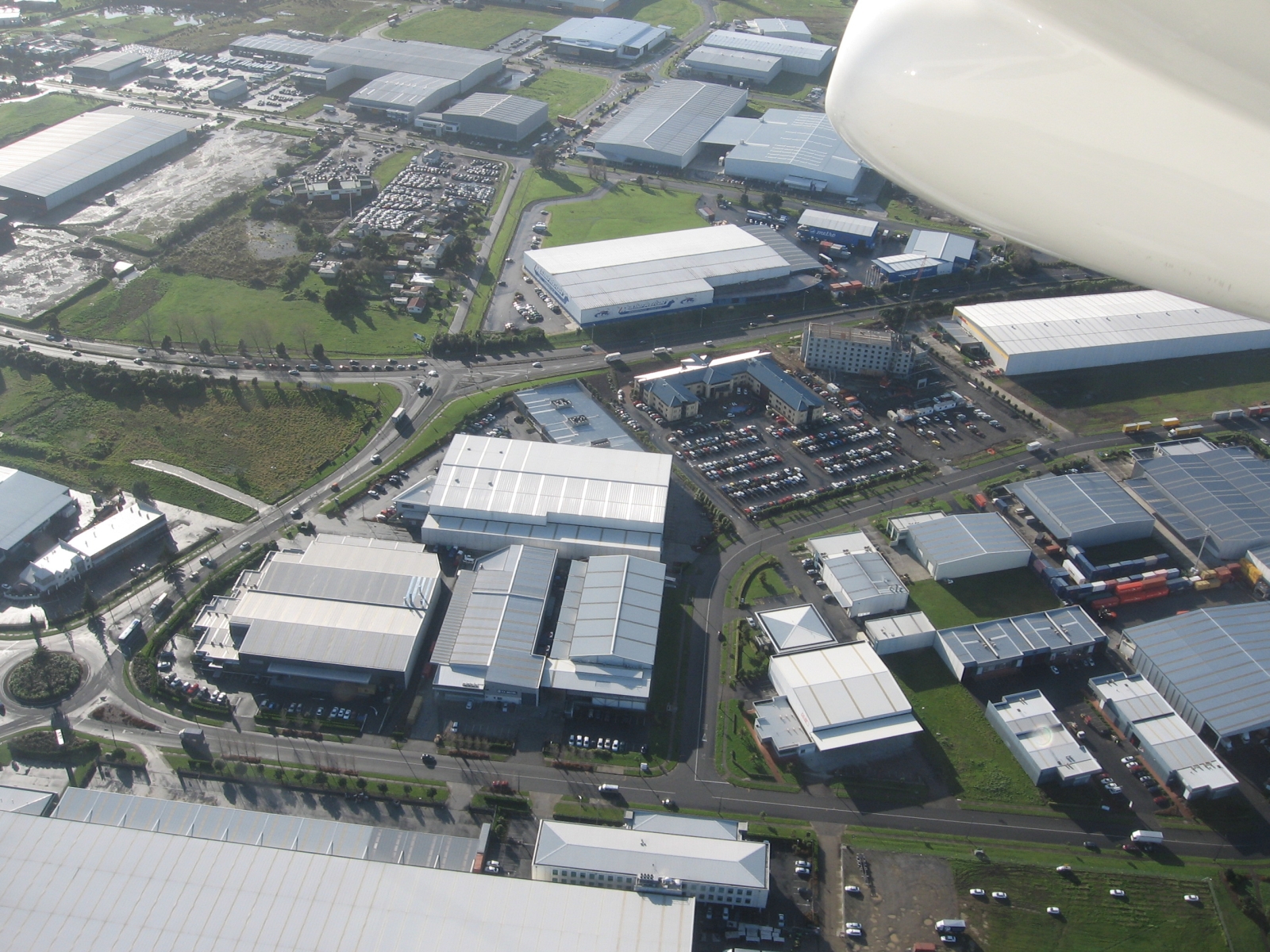 Aerial view of the industrial area immediately north of Auckland Airport, with warehouses, car parks and hotel buildings