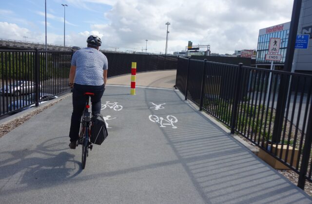 A cyclist riding a separated cycleway ramp in central Auckland