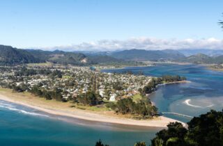Looking down from Mount Paku over the town of Tairua, its estuary and the ocean beach on the Coromandel coast